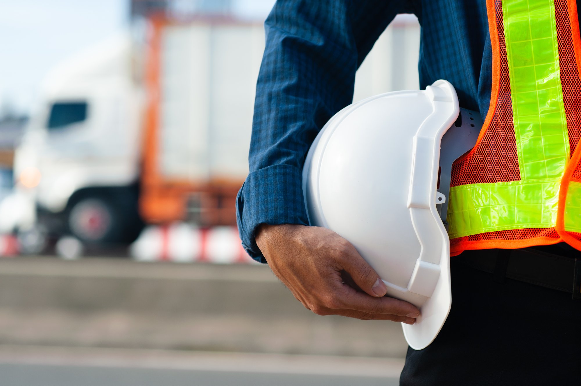 close-up-engineering-holding-white-helmet-hard-hat-safety-road-construction-background